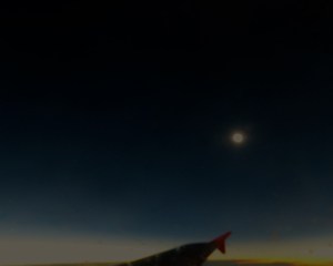 Eclipsed Sun with Moon's shadow overhead.